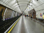 The nickname "the Tube" comes from the circular tube-like tunnels and platforms through which the trains travel. This photograph shows a southbound Northern line station platform at Angel tube station.