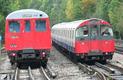 Underground trains come in two sizes, larger subsurface trains and smaller tube trains. A Metropolitan line A Stock train (left) passes a Piccadilly line 1973 Stock train (right) in the siding at Rayners Lane