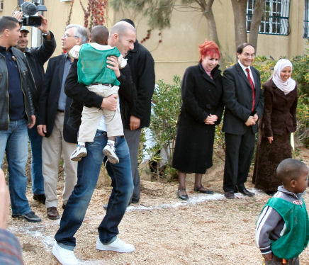 Zinedine Zidane with child at the SOS Medical Centre in Thenia, Algeria
