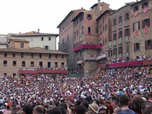 Thousands of spectators, coming from all the world, fill the Piazza del Campo to capacity on the day of the Palio di Siena.