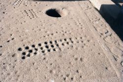 Ancient Gebeta (i.e. mancala) holes in the base of an Aksumite stele, Axum, Ethiopia.