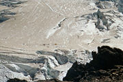 Mountaineers descending from the summit avoid crevasses above Emmons Flats Camp.