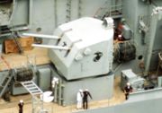 A 5-inch (127 mm) gun mount emblazoned with the Eagle, Globe, and Anchor of the United States Marine Corps aboard the battleship New Jersey