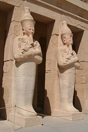 Osirian statues of Hatshepsut at her tomb, one stood at each pillar of the extensive structure, note the mummification shroud enclosing the lower body and legs as well as the crook and flail associated with Osiris