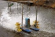 A one-horsepower paddlewheel aerator. The splashing may increase the evaporation rate of the water and thus increase the salinity of the pond.