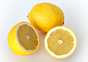 Two lemons, one whole and one sliced  in half