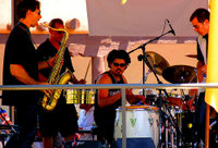 A modern salsa band lineup including less traditional salsa instruments such as a saxophone and a full drumset