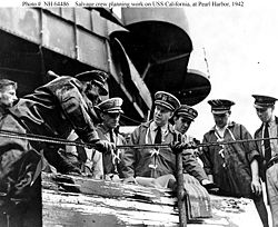 Captain Homer N. Wallin (center) supervises salvage operations aboard USS California, early 1942