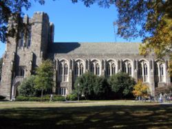 Students walk in front of the Perkins Library at Duke University.