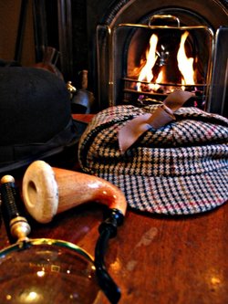 "Holmes' belongings" including a magnifying glass, calabash pipe, and a deerstalker cap at the Sherlock Holmes Museum in London.