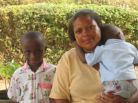 John with his SOS Mother and one of his seven SOS siblings